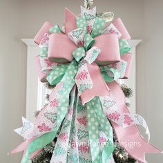 a pink and green christmas tree with polka dot bows