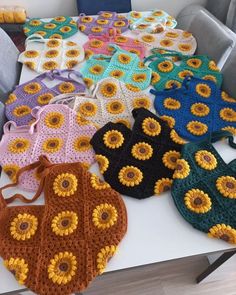 crocheted sunflower purses on a table