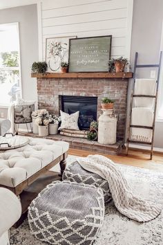 a living room filled with furniture and a fire place in front of a brick fireplace