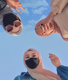 three people wearing masks standing in the air