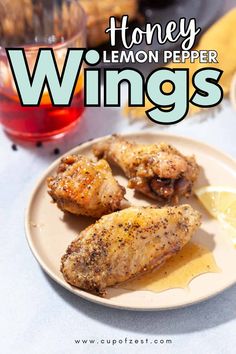 Three crispy honey lemon pepper chicken wings on a light-colored plate, garnished with a lemon slice and a drink with a red-orange hue in the background. Honey Lemon Pepper Wings, Wings Recipes, Lemon Pepper Wings, Citrus Twist, Spicy Honey, Party Snack, Honey Lemon, Lemon Pepper, Perfect Party