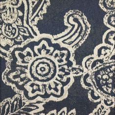 a blue and white area rug with an intricate design on the top, in front of a black background