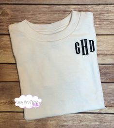 "These monogrammed t-shirts are made of a comfortable cotton fabric, making a casual, yet stylish, addition to the wardrobe of any boy. I offer boys t-shirts using four different styles of fonts. Shirts ordered from this listing will be monogrammed using a formal font as shown in the listing picture. The order of the letters will be FIRST NAME - LAST NAME - MIDDLE NAME. IMPORTANT: When placing your order please provide the following information - 1. The full name of the person and I will put the White Monogram Crew Neck T-shirt, White Cotton T-shirt With Monogram Print, Personalized White Crew Neck Shirt, White Personalized Crew Neck Shirt, Monogrammed Short Sleeve Cotton T-shirt, Personalized Black Cotton Tops, Customizable White Cotton Shirt, Basic Personalized Cotton Tops, White Monogram T-shirt With Crew Neck