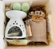 an open box containing various items such as candles, soaps and other things in it