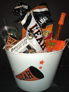 a white bucket filled with candy and candies