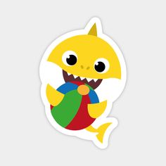 a sticker with an image of a yellow shark holding a ball in it's mouth