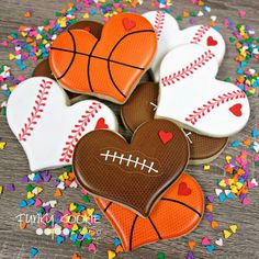 decorated cookies in the shape of basketballs and hearts