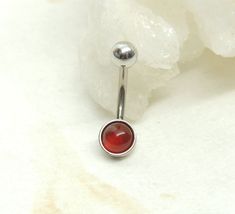 Carnelian Belly Ring  14g surgical steel non dangle style belly ring features a beautiful carnelian agate gemstone cabochon. I do offer this belly ring with a larger 8mm stone, please see link below.   Belly ring is solid surgical steel with a SMALL 6mm gemstone cabochon. Belly button ring measures approx.  1 inches long total length with a 12mm wearable bar length.  8mm Carnelian Belly Ring: https://www.etsy.com/listing/614019008/carnelian-agate-belly-ring-non-dangle?ref=shop_home_active_4&pro= Belly Button Piercing Tear Drop, Simple Belly Button Rings, Nickel-free Round Stainless Steel Belly Rings, Hypoallergenic Stainless Steel Belly Rings As Gifts, Simple Belly Button Piercing, Unique Belly Rings