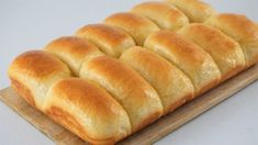 a loaf of bread sitting on top of a wooden cutting board