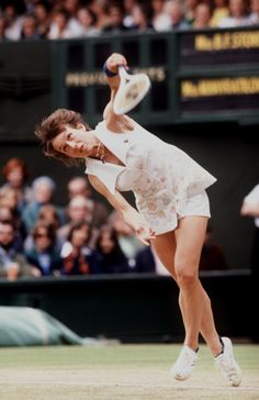 a tennis player in mid air after hitting the ball with his racket during a match