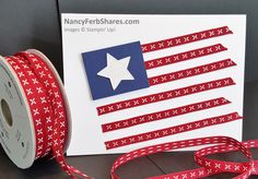 a red white and blue ribbon is next to a card with an american flag on it