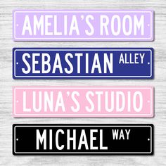 three street signs with names on them in pink, blue and purple colors against a white background