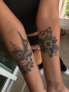 two people with tattoos on their legs and one has a bird tattoo on her arm