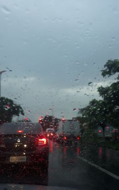 rain is pouring down on the windshield of a car