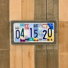 a license plate is hanging on a wooden wall