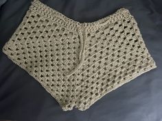 a crocheted shorts is laying on a bed