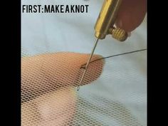 someone is cutting through the mesh with a needle