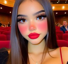 a mannequin with long hair and red lipstick in front of an auditorium full of people