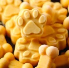 some yellow and white candies with a dog paw on it's front end