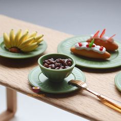 three green plates with food on them sitting on a table