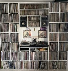 a room filled with lots of different types of records and audio equipment on shelves next to each other