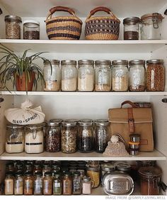 the shelves are filled with many different types of jars and containers, including one for spices