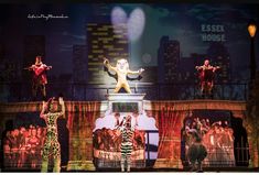 the cast of cats on stage performing in front of a group of people wearing costumes