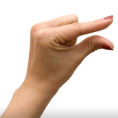 a woman's hand is holding an object in the air with her thumb up