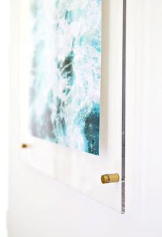 a painting hanging on the wall next to a door handle