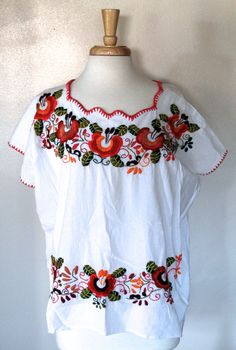 a white top with red flowers on it