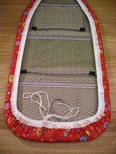 an ironing board is sitting on the floor with its cover pulled back to dry