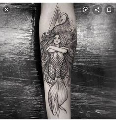 a woman's leg with a tattoo on it and a mermaid hugging her arm