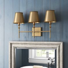 a bathroom with blue walls and gold fixtures