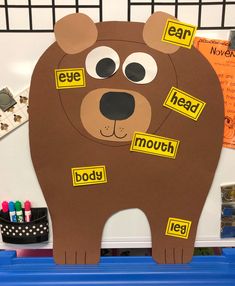 a brown bear cut out with words on it