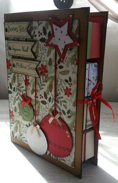 a christmas card with ornaments hanging from it's front and back sides, on a table