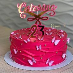 a pink birthday cake with butterflies on it and the number twenty five in gold lettering