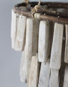 several pieces of wood hanging from a rope