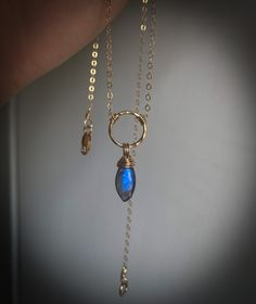 This is a handmade 46 cm/18 in necklace made with 14K gold filled chain and wire, a hammered 12 mm ring, a marquise shaped labradorite stone with a beautiful indigo blue coloured flash and a lobster clasp closure. Marquise Blue Stone Gold Necklace, Gold Filled Ring, Hammered Gold, Ring Pendant, Ring Pendant Necklace, Labradorite Stone, Gold Filled Chain, Indigo Blue, Crystal Necklace