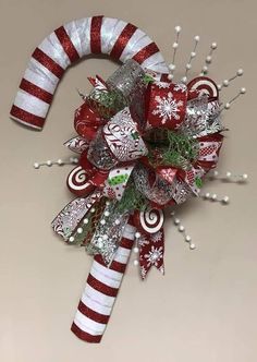 a candy cane decorated with christmas decorations