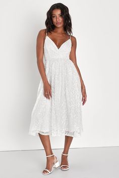 You'll be unforgettable when you arrive at the party in the Lulus Dreamy Drama White Lace Sequin A-Line Midi Dress! Gorgeous lace, with sparkling sequins throughout, overlays this perfect dress. Adjustable spaghetti straps support a surplice bodice with flattering seaming and a fitted waist. A-line skirt falls to a flattering midi hem. Hidden zipper/clasp at back for fit. Fit: This garment fits true to size. Length: Mid-calf length. Size medium measures 41" from adjustable straps to hem. Bust: G White V-neck Dress For Bridal Shower, White Midi Dress For Prom, Lace Midi Bridesmaid Dress With Sweetheart Neckline, Lace Midi Dress With Sweetheart Neckline For Bridesmaids, White Bridesmaid Midi Dress With Sweetheart Neckline, Lace Midi Dress With Sweetheart Neckline For Wedding, White Midi Dress With Sweetheart Neckline For Wedding, White Wedding Midi Dress With Sweetheart Neckline, Sleeveless Lace Dress For Bridal Shower