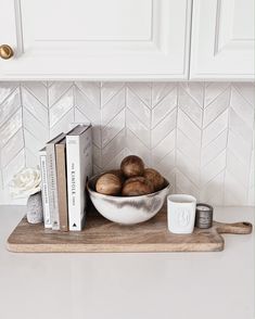 a bowl of mushrooms and books on a cutting board