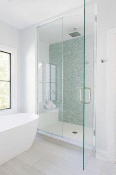 a white bath tub sitting next to a window