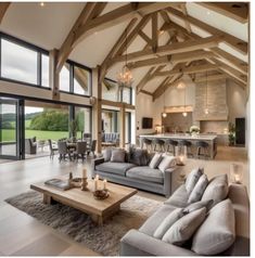 a living room filled with lots of furniture next to a large open floor plan area