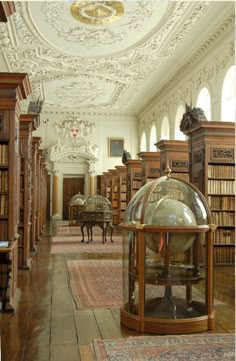 an old library with lots of books on the shelves and antique globes in it