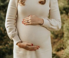 a pregnant woman with her hands on her belly