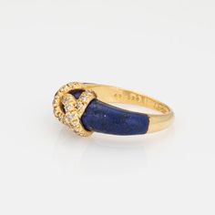 Vintage "Double C" Cartier diamond ring crafted in 18k yellow gold.    Diamonds total an estimated 0.15 carats (estimated at G-H color and VS2-SI1 clarity). Lapis lazuli tapers and measures from 6mm to 4.5mm. Note: some wear to the lapis (surface abrasions) and a small fissure underneath the CC logo (visible under a 10x loupe).    The elusive 'Double C' ring is a classic made by Cartier in the 1970s. Diamonds adorn the 'CC' motif, perched upon rich cobalt blue lapis lazuli. The ring is great worn alone or stacked with your fine jewelry from any era and would also make a unique choice as an alternative wedding ring. The intertwining 'Cs' make a nice representation of a couple joining together as one. The ring does not come with Cartier papers or a box.   The ring is in good condition and wa Vintage Cartier Diamond Jewelry, Cartier Yellow Gold Diamond Ring For Anniversary, Cartier Yellow Gold Jewelry With Prong Setting, Cartier Fine Jewelry Rings With Prong Setting, Cartier Yellow Gold Diamond Ring With Accents, Cartier Rings With Prong Setting Fine Jewelry, Cartier Yellow Gold Diamond Ring With Brilliant Cut, Cartier Rings With Prong Setting, Classic Cartier Rings With Prong Setting