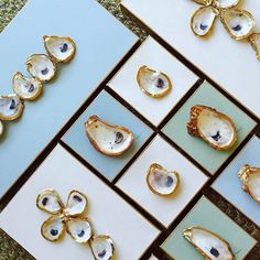 several pieces of jewelry sitting on top of a blue and white table next to each other