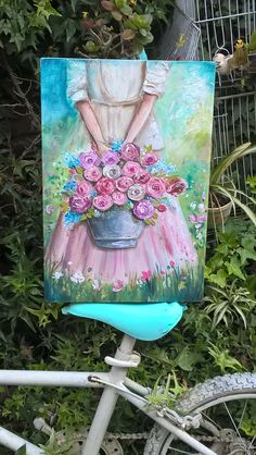 a painting of a woman with flowers in a blue vase on a bicycle handlebar