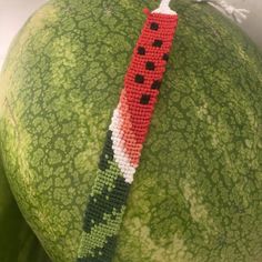 a close up of a watermelon with a piece of bead on it