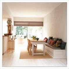 a living room and dining area with white walls